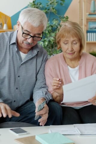 Couple reviewing health plan documents together at home