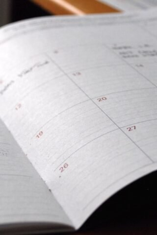Open monthly calendar planner on a desk representing enrollment deadlines