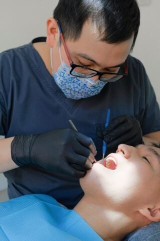 Dentist performing a dental check-up on a patient