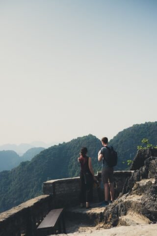 Active couple hiking at a scenic mountain viewpoint enjoying early retirement