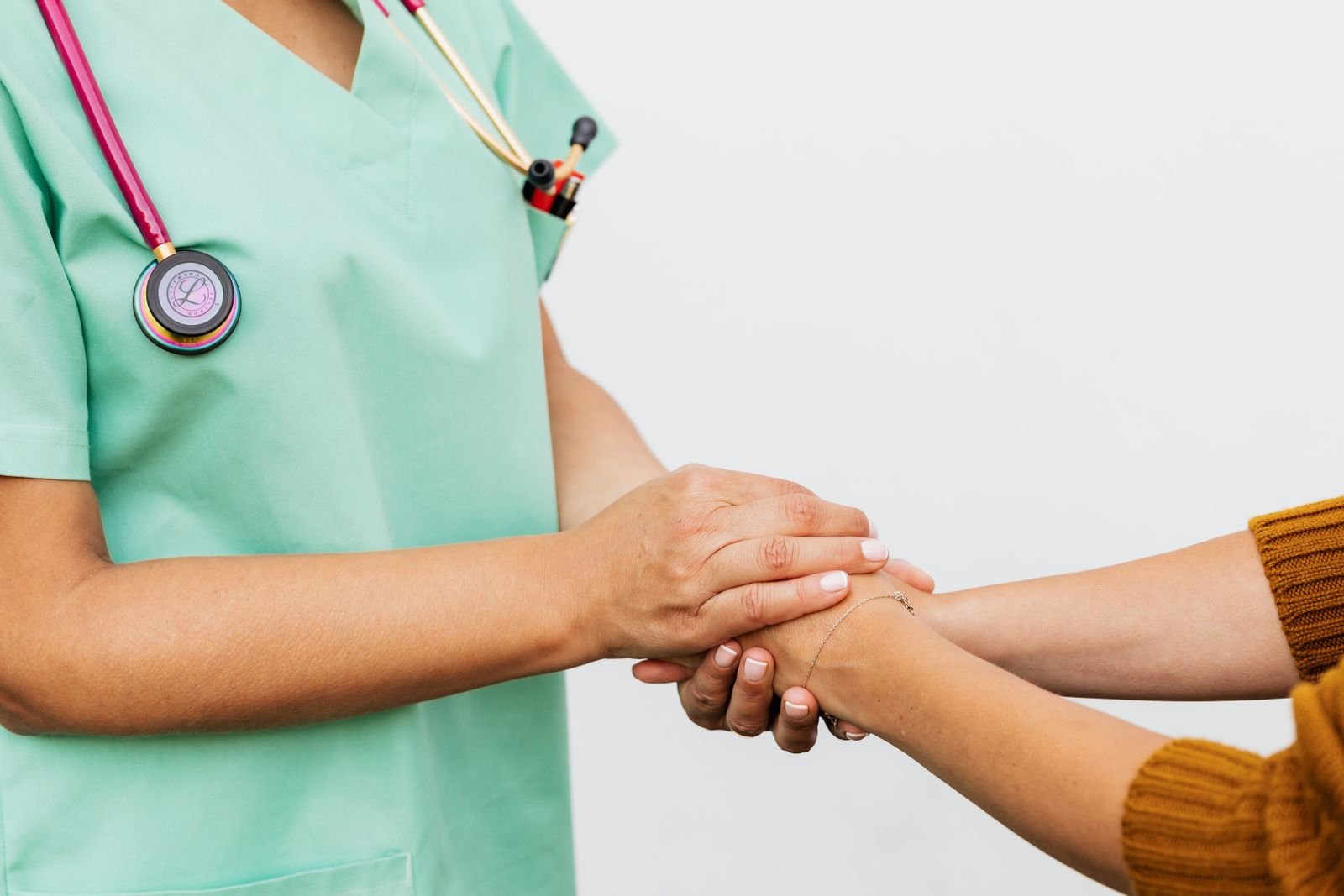 Doctor holding a patient's hand — keeping the doctor you trust