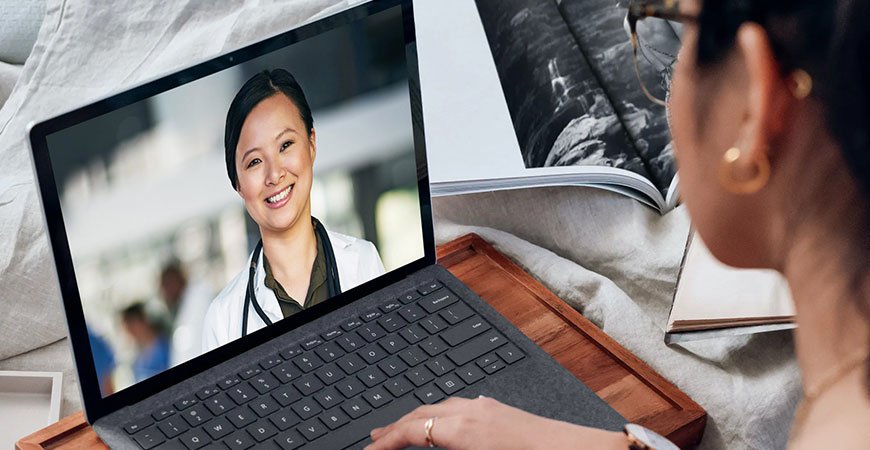 Woman consulting with doctor via telemedicine